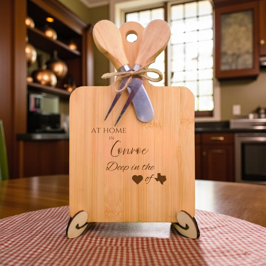 Bamboo charcuterie board engraved with “At Home in Conroe, Deep in the Heart of Texas” displayed in a kitchen setting.