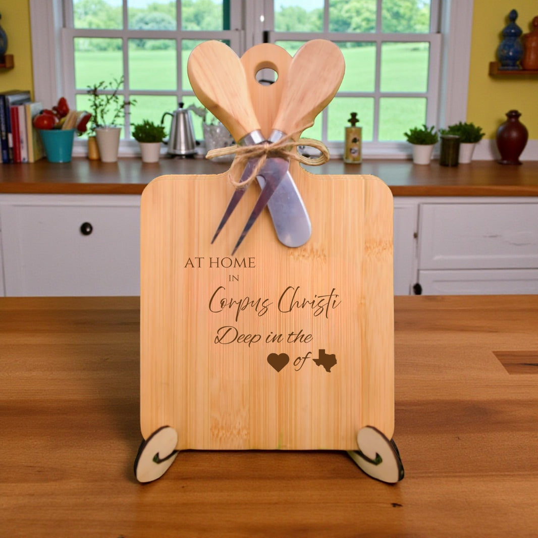 Bamboo charcuterie board engraved with “At Home in Corpus Christi, Deep in the Heart of Texas” displayed in a kitchen setting.