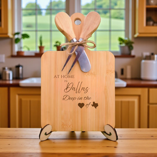 Bamboo charcuterie board engraved with “At Home in Dallas, Deep in the Heart of Texas” displayed in a bright kitchen setting.