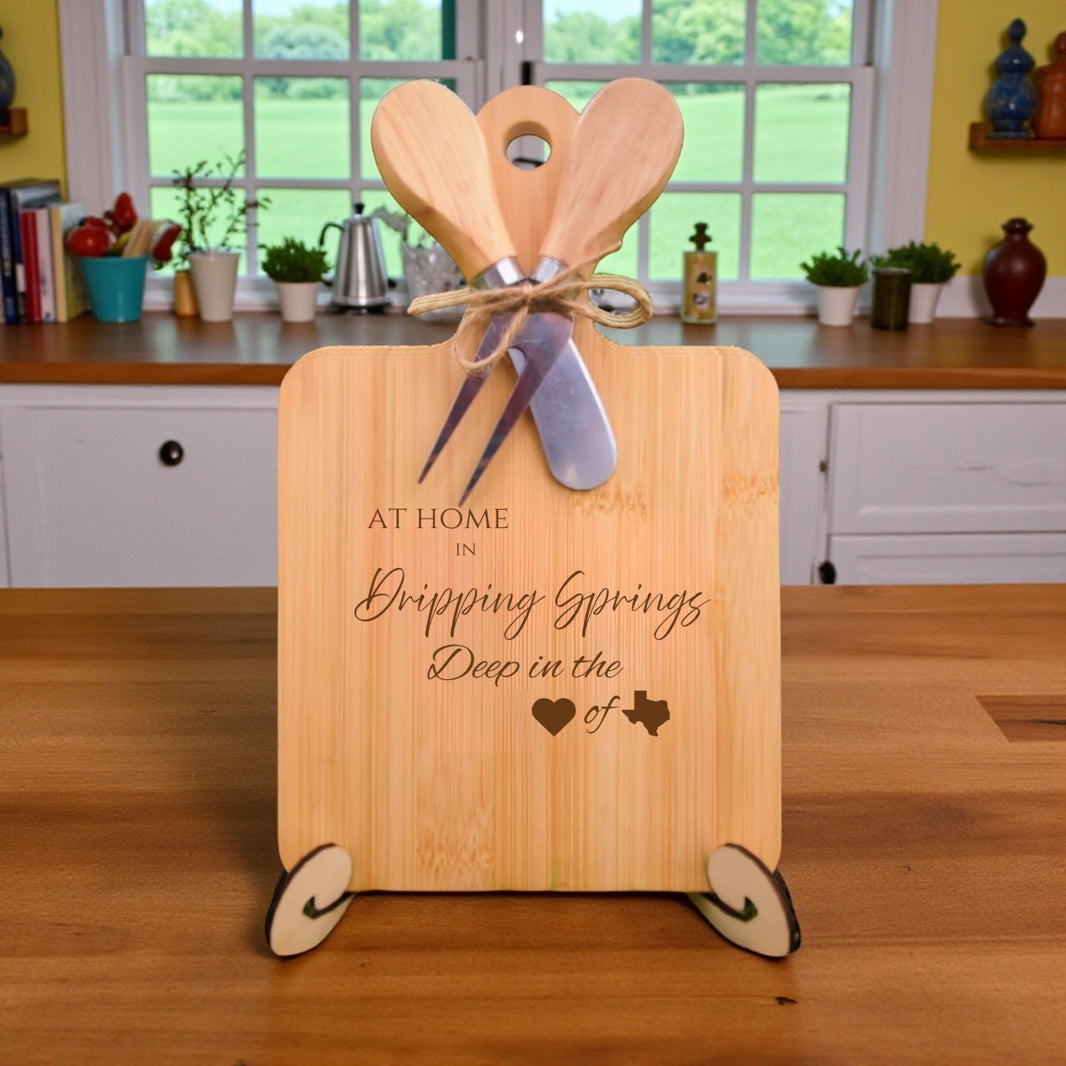 Bamboo charcuterie board engraved with “At Home in Dripping Springs, Deep in the Heart of Texas” displayed in a cozy kitchen setting.