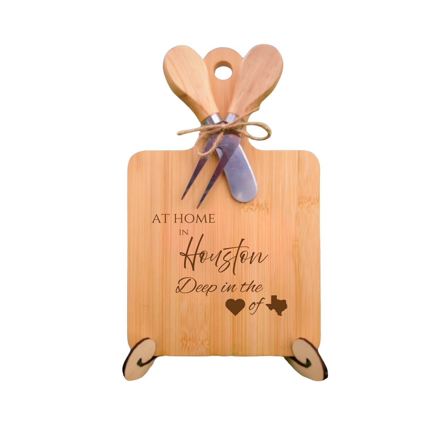 Elegant bamboo charcuterie board with utensils, engraved with “At Home in Houston, Deep in the Heart of Texas.”