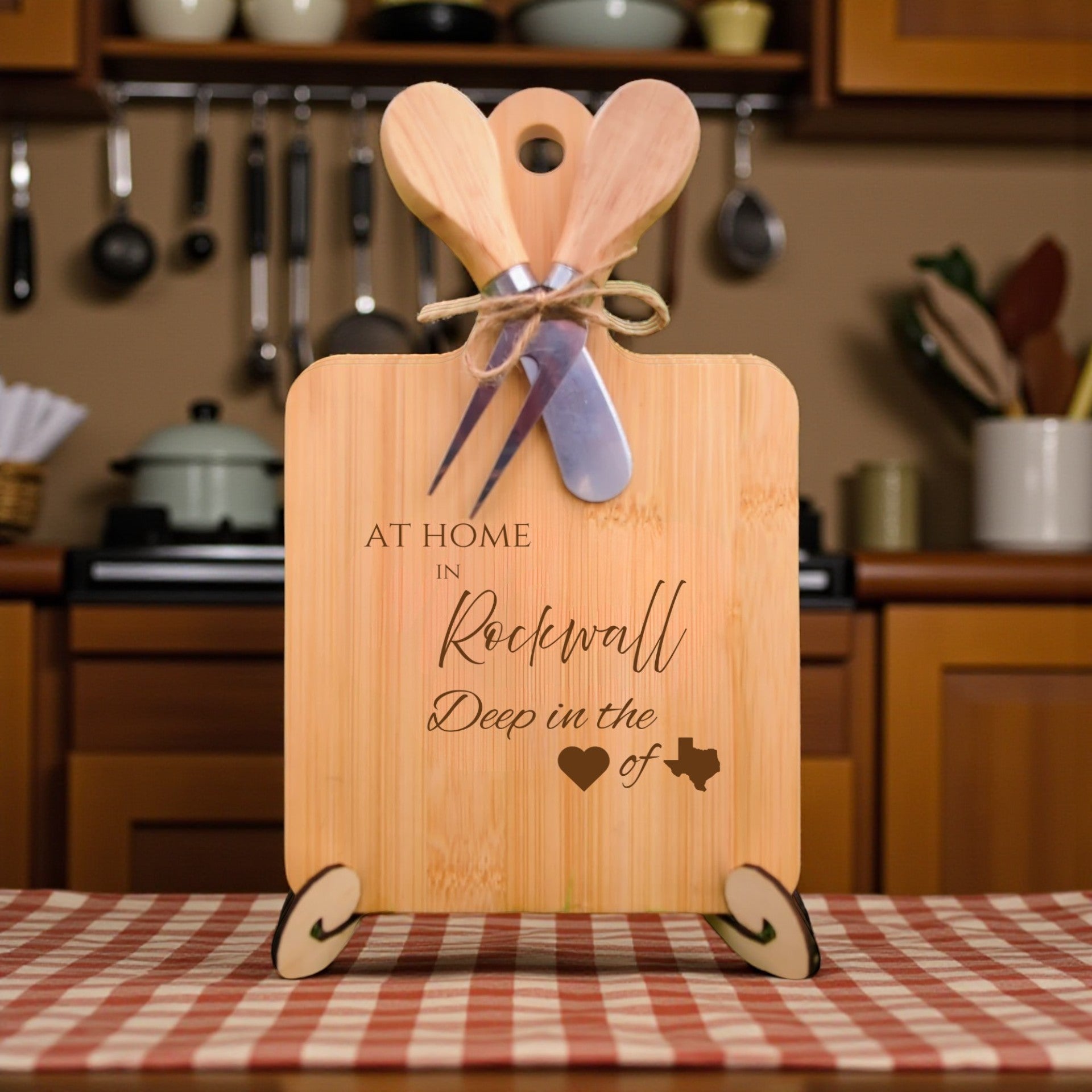 Bamboo charcuterie board engraved with “At Home in Rockwall, Deep in the Heart of Texas” displayed in a kitchen setting.