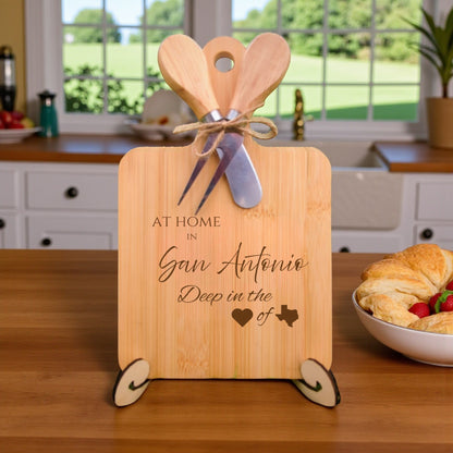 Bamboo charcuterie board engraved with “At Home in San Antonio, Deep in the Heart of Texas” displayed in a kitchen setting.