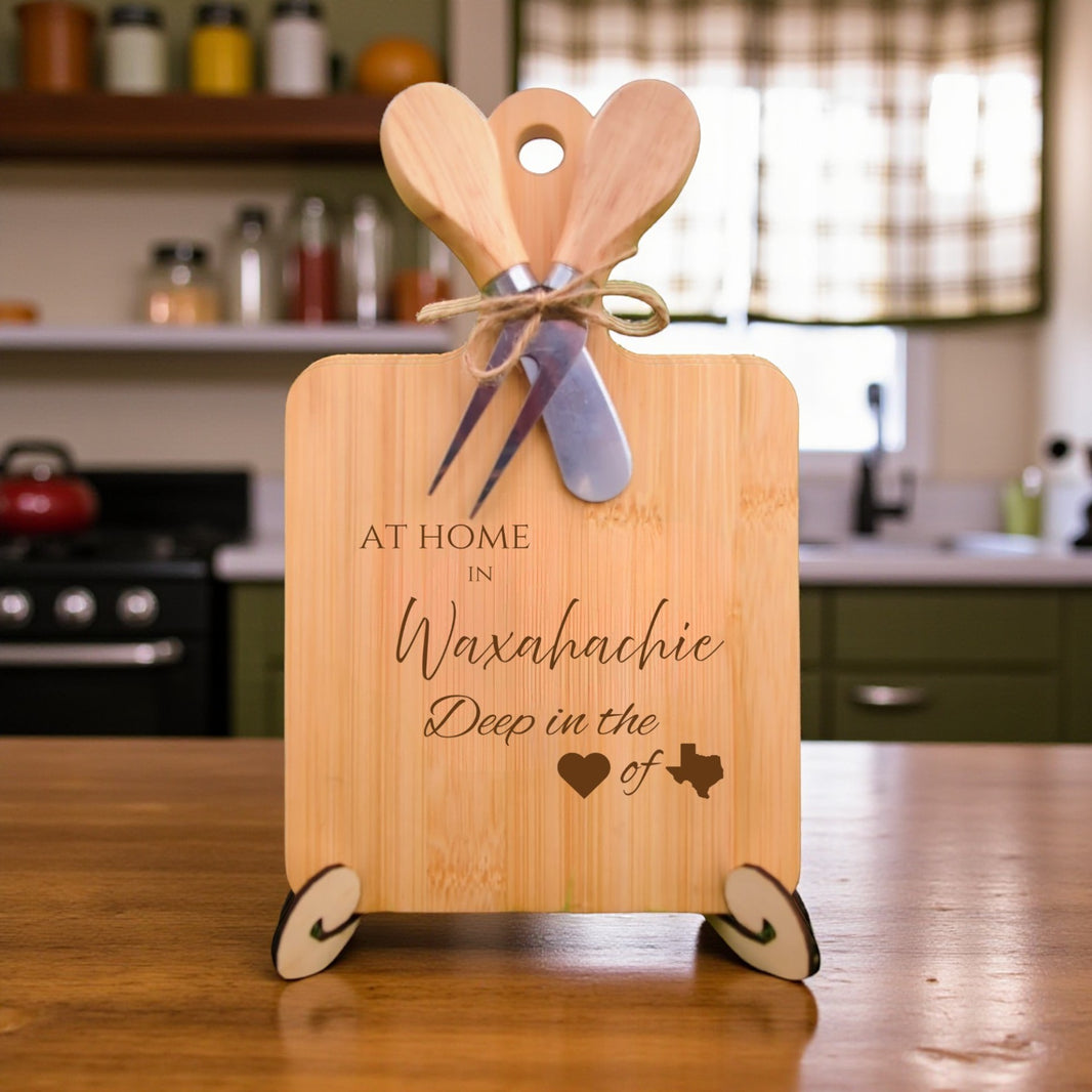 Bamboo charcuterie board engraved with “At Home in Waxahachie, Deep in the Heart of Texas” displayed in a farmhouse kitchen with rustic décor.