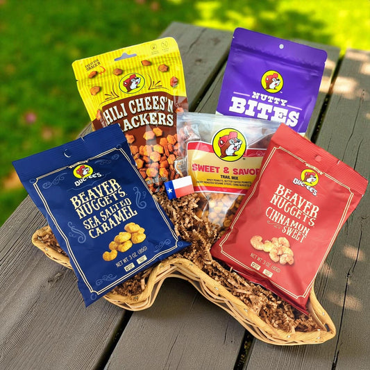 A Buc-ees themed snack gift basket from Texas in a Texas-shaped basket, filled with beaver nuggets, trail mix, nutty bites, and other Buc-ees Texas snacks