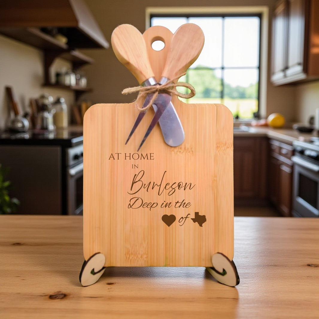 Bamboo charcuterie board engraved with “At Home in Burleson, Deep in the Heart of Texas” displayed in a cozy kitchen setting.