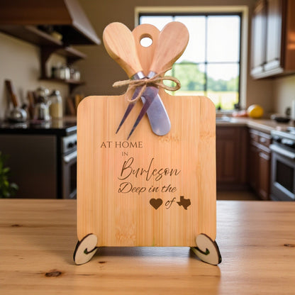 Bamboo charcuterie board engraved with “At Home in Burleson, Deep in the Heart of Texas” displayed in a cozy kitchen setting.