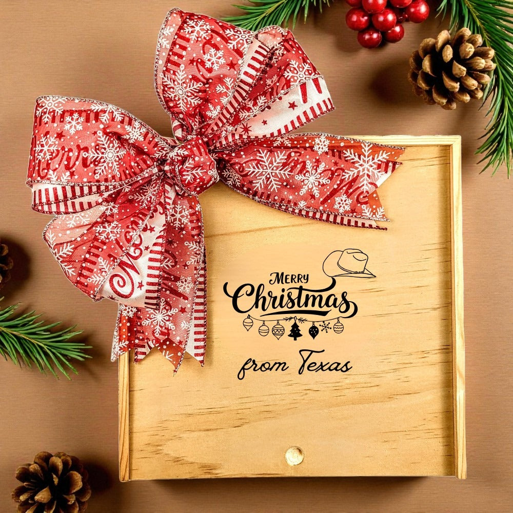 Create Your Own Merry Christmas from Texas Wood Gift Box with a festive red snowflake bow and a “Merry Christmas from Texas” design, surrounded by holiday greenery and pinecones.