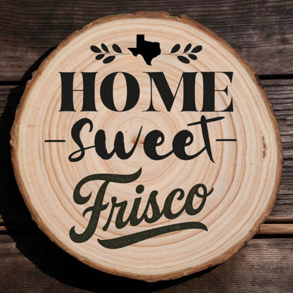 Rustic wood slice coaster with “Home Sweet Frisco” laser engraving, Texas silhouette, and leafy accents on wood background.