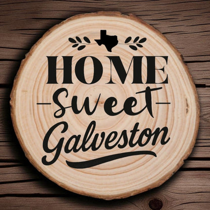 Rustic wood slice coaster with “Home Sweet Galveston” laser engraving, Texas silhouette, and leafy accents on wood background.