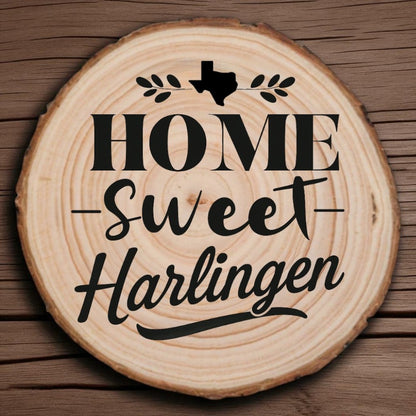 Rustic wood slice coaster with “Home Sweet Harlingen” laser engraving, Texas silhouette, and leafy accents on wood background