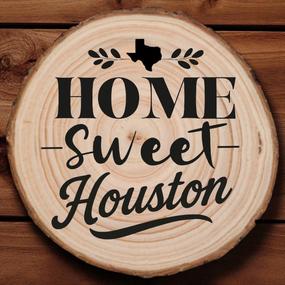 Rustic wood slice coaster with “Home Sweet Houston” laser engraving, Texas silhouette, and leafy accents on wood background