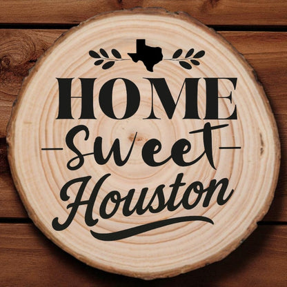 Rustic wood slice coaster with “Home Sweet Houston” laser engraving, Texas silhouette, and leafy accents on wood background