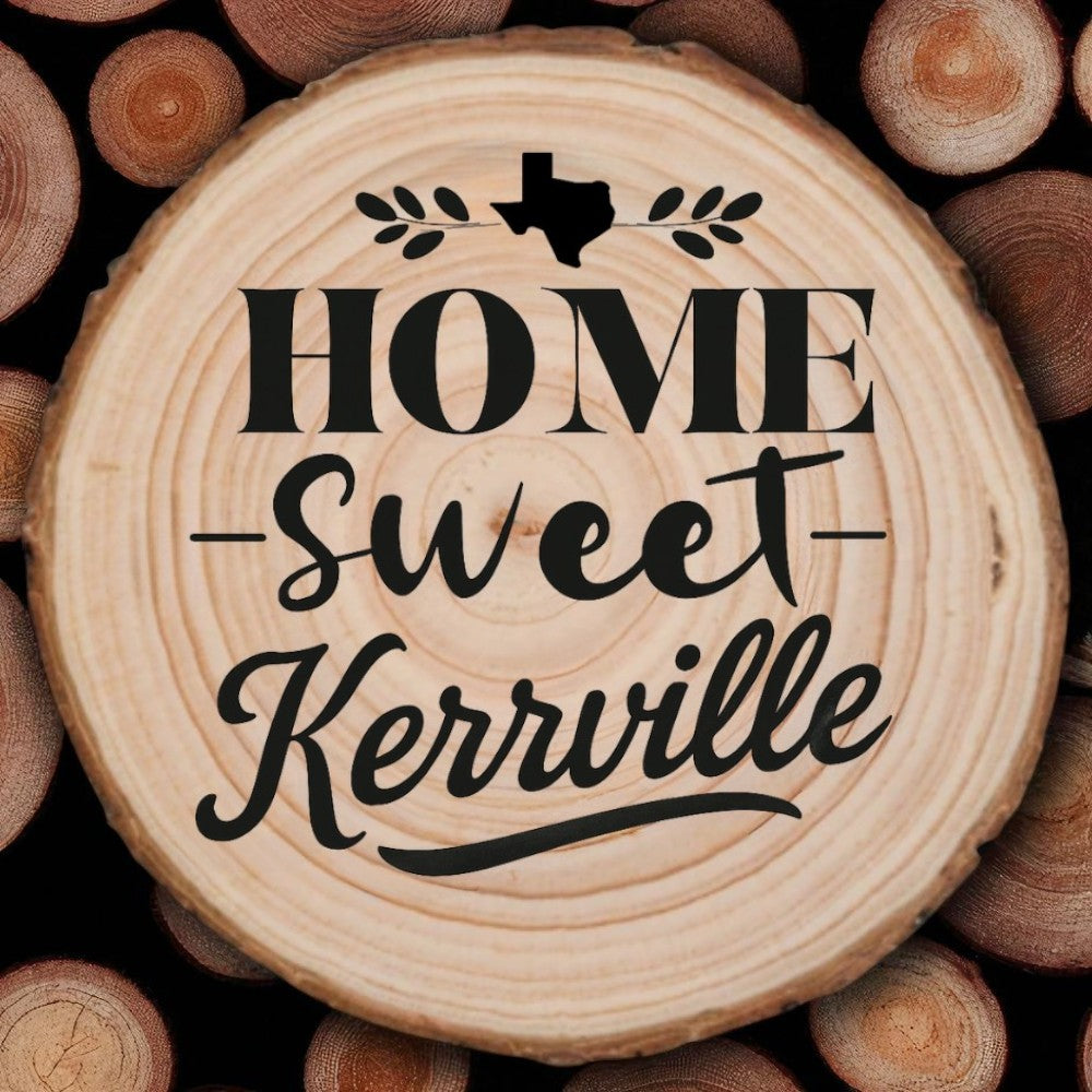 Rustic wood slice coaster with “Home Sweet Kerrville” laser engraving, Texas silhouette, and leafy accents on wood background.