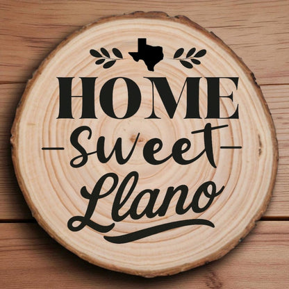 Rustic wood slice coaster with “Home Sweet Llano” laser engraving, Texas silhouette, and leafy accents on wood background.