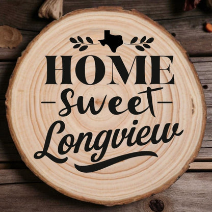 Rustic wood slice coaster with “Home Sweet Longview” laser engraving, Texas silhouette, and leafy accents on wood background