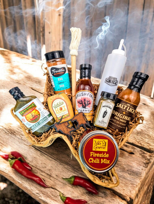 Lone Star Smoke Stack Texas BBQ gift basket with premium sauces, seasonings, and tools like Brushfire Glaze and Franklin BBQ Rub, arranged in a Texas-themed basket on a rustic wooden table.