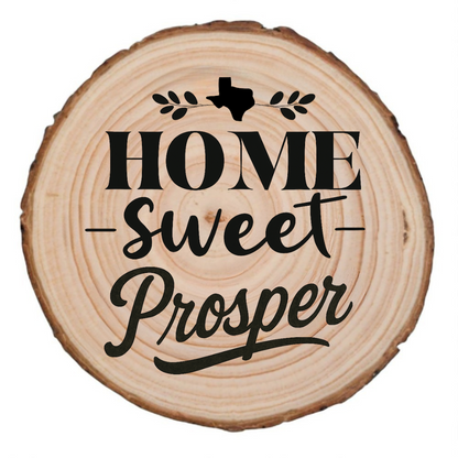 Natural wood slice coaster with “Home Sweet Prosper” laser engraving and Texas silhouette on white background.