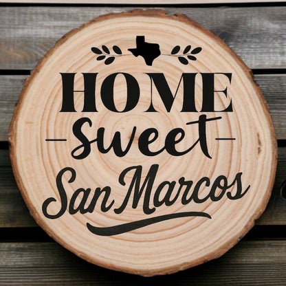 wood slice coaster with “Home Sweet San Marcos” laser engraving, Texas silhouette, and leafy accents on wood background