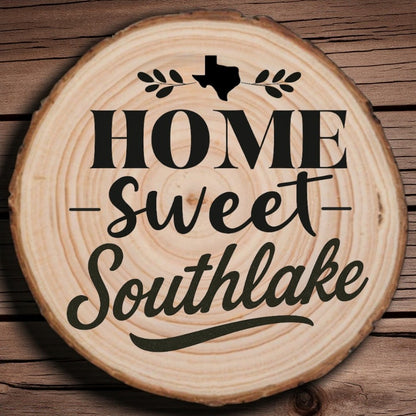 Rustic wood slice coaster with “Home Sweet Southlake” laser engraving, Texas silhouette, and leafy accents on wood background.