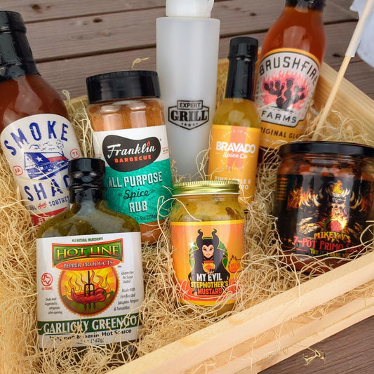 a large gift crate filled with texas bbq foods including bbq seasoning, hot mustard, bbq sauce, salsa, and glaze
