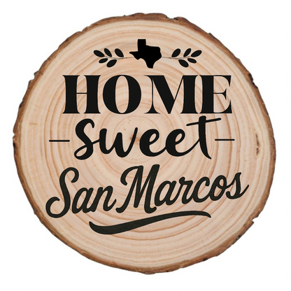 Natural wood slice coaster with “Home Sweet San Marcos” laser engraving and Texas silhouette on white background.