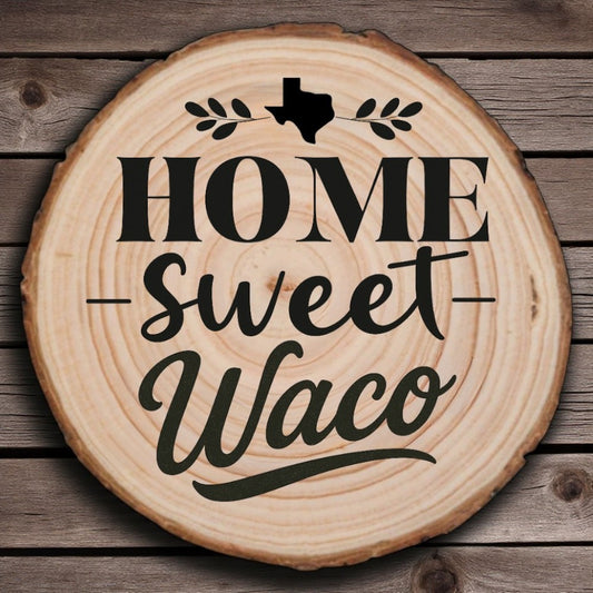 Rustic wood slice coaster with “Home Sweet Waco” laser engraving, Texas silhouette, and leafy accents on wood background.