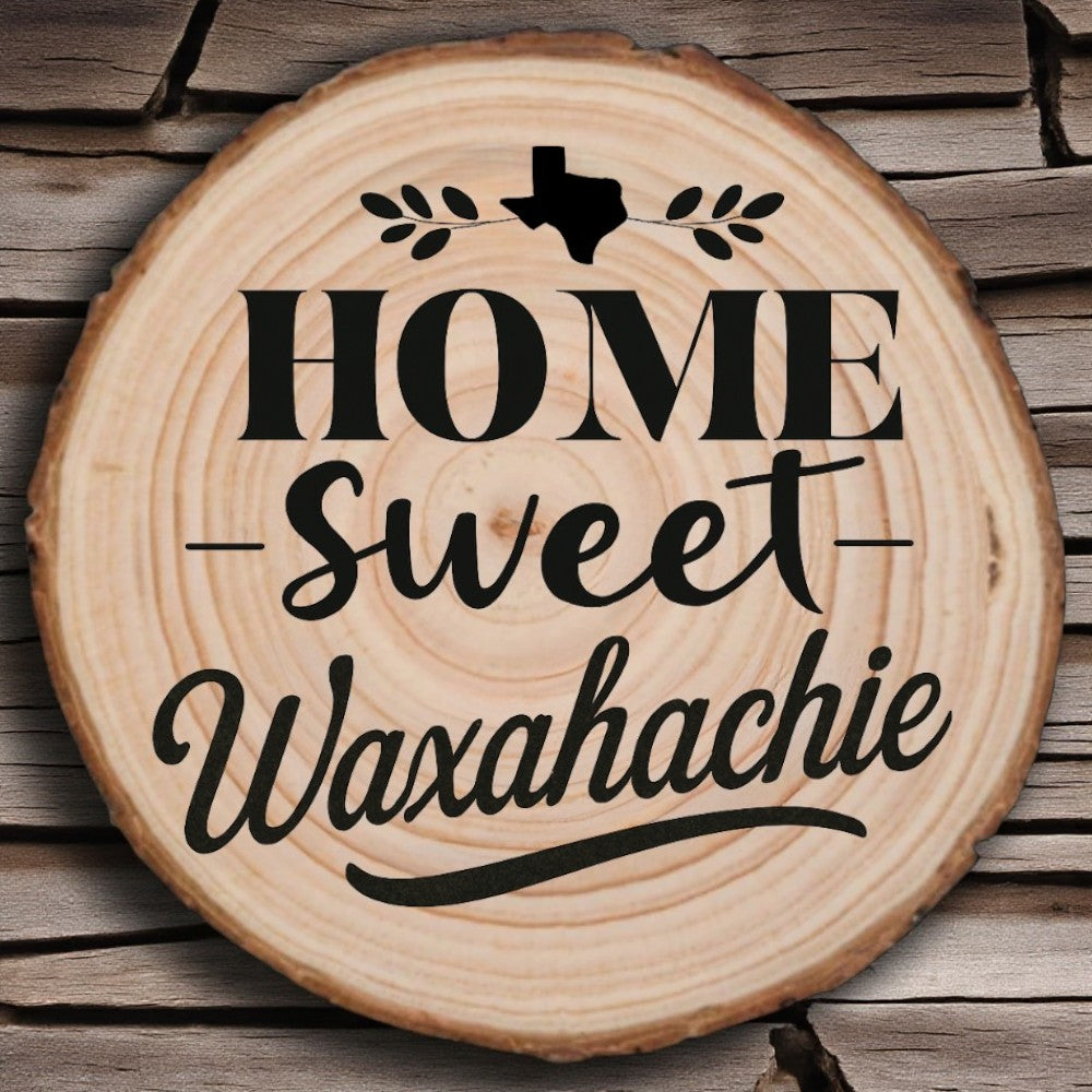 Rustic wood slice coaster with “Home Sweet Waxahachie” laser engraving, Texas silhouette, and leafy accents on wood background.