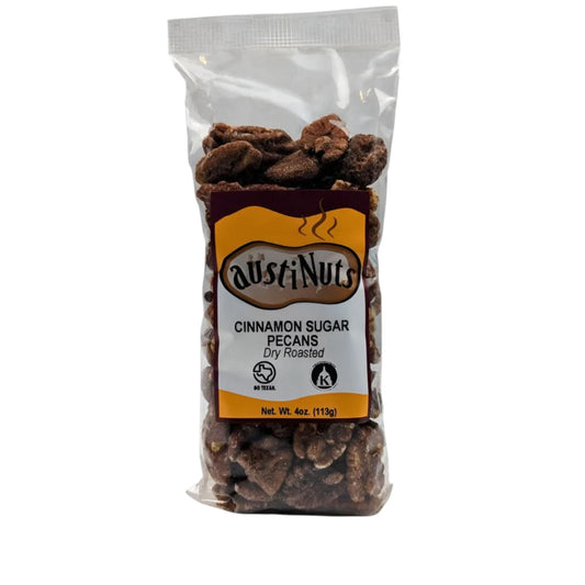 Clear bag of AustiNuts cinnamon sugar pecans, dry roasted, 4 oz package with visible pecans and front label