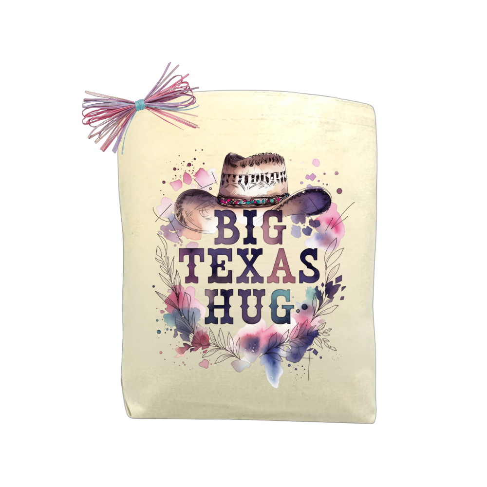 Big Texas Hug Cowgirl Edition gift tote with floral cowgirl hat design, isolated on a black background for product display.