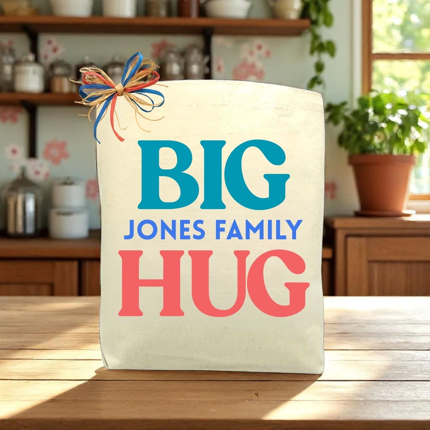 Canvas bag with 'BIG JONES FAMILY HUG' text on a wooden table.