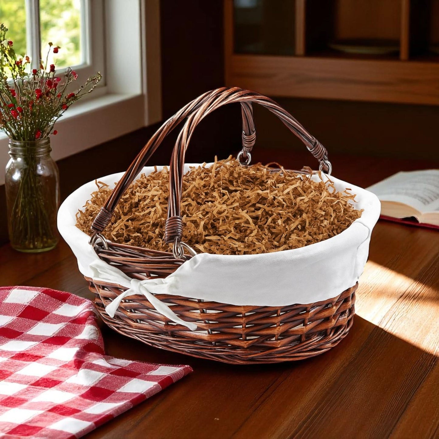 brown will basket with two handles and a liner filled with gift shred paper on a country kitchen table