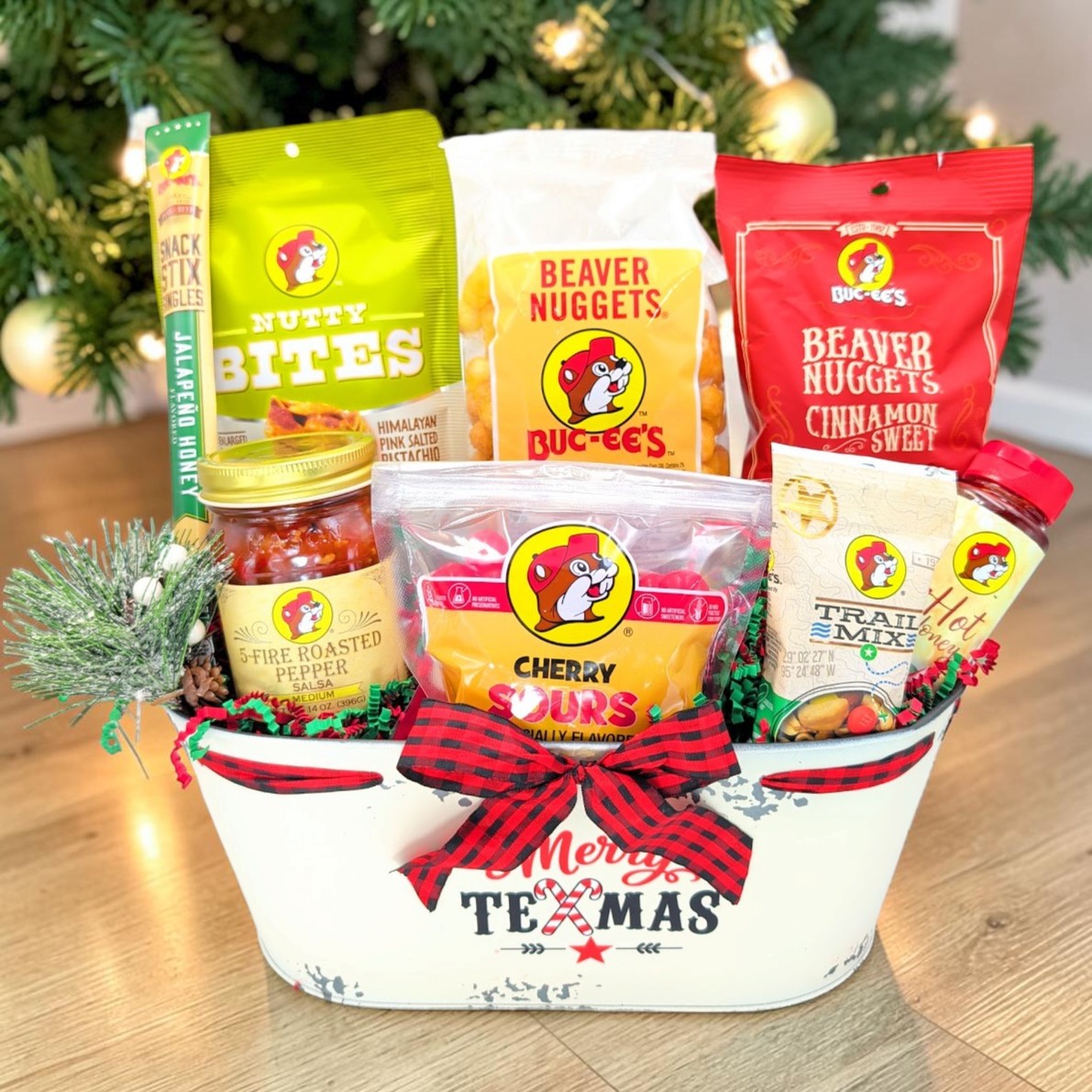 Buc-ee’s Merry Texmas Treats Christmas gift in a white tin tub with buffalo-check bow, front view
