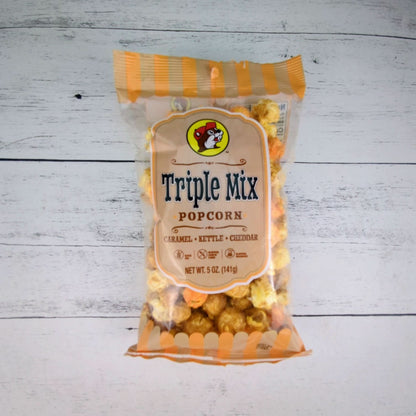 a package of buc-ees triple mix popcorn with caramel, kettle, and cheddar flacors. 