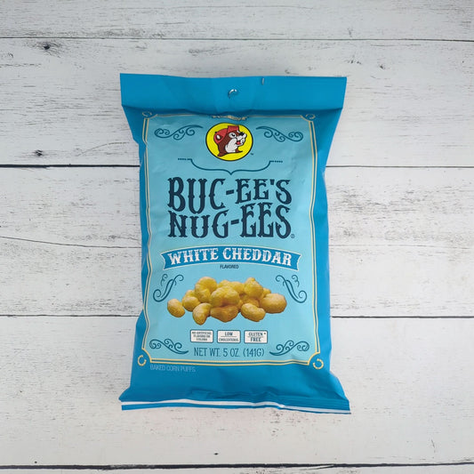 a light blue 5oz package of bucees nugees white cheddar beaver nugget snacks, available for inclusion in a texas-themed gift basket, box, or tote
