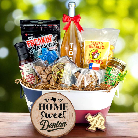 Denton Texas Toast & Treats Home Basket with TÖST ROSÉ, Peach Pepper Jelly, Buc-ee’s Beaver Nuggets, Texas pecans, praline, chipotle sauce, and Texas flag tin