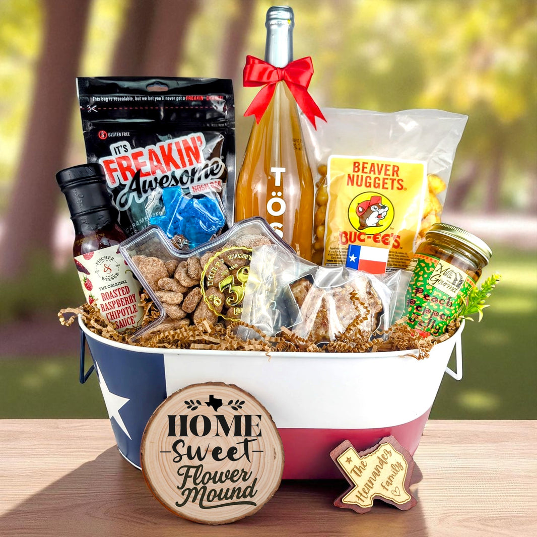 Flower Mound Texas Family Home Toast & Treats basket with TÖST ROSÉ, Peach Pepper Jelly, Buc-ee’s Beaver Nuggets, Texas pecans, praline, chipotle sauce, and Texas flag tin