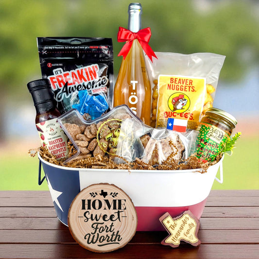 Fort Worth Texas Home Celebration Toast & Treats basket with TÖST ROSÉ, Peach Pepper Jelly, Buc-ee’s Beaver Nuggets, Texas pecans, praline, chipotle sauce, and Texas flag tin