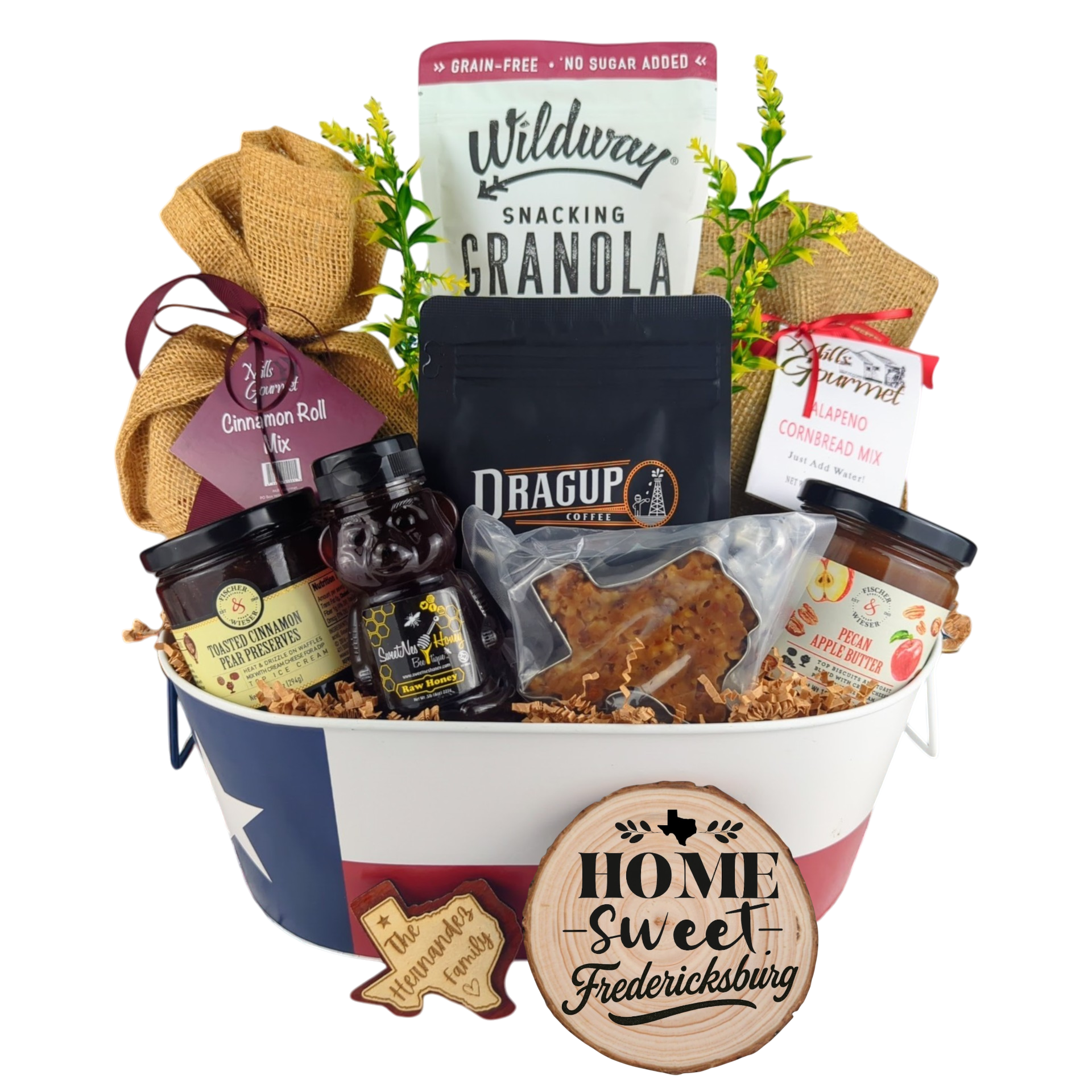 Fredericksburg Family Breakfast Basket on a white background, showcasing pecan coffee, granola, cinnamon rolls, jalapeño cornbread mix, pecan apple butter, raw honey, and praline.