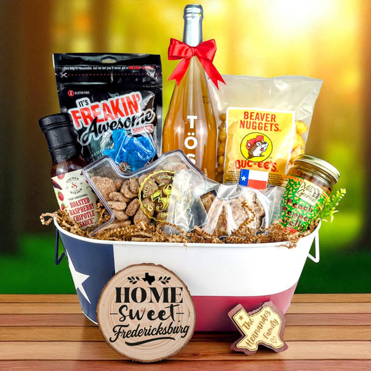 Fredericksburg Texas Welcome Home Toast & Treats basket with TÖST ROSÉ, Peach Pepper Jelly, Buc-ee’s Beaver Nuggets, Texas pecans, praline, chipotle sauce, and Texas flag tin