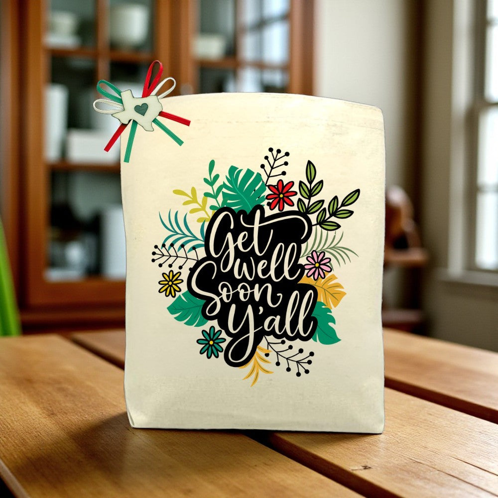 Get Well Soon Y’all canvas tote bag with uplifting Southern-inspired design, displayed on a wooden table