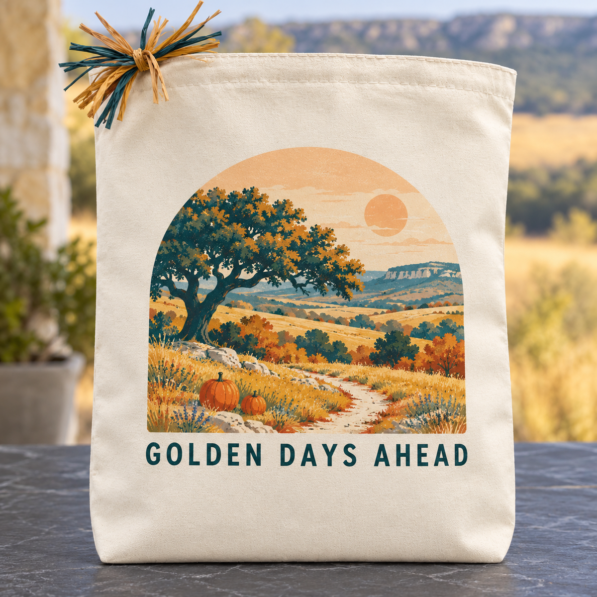 Cream canvas Golden Days Ahead fall gift tote. An arched autumn Hill Country landscape pairs teal oaks and golden hills with a hopeful message.