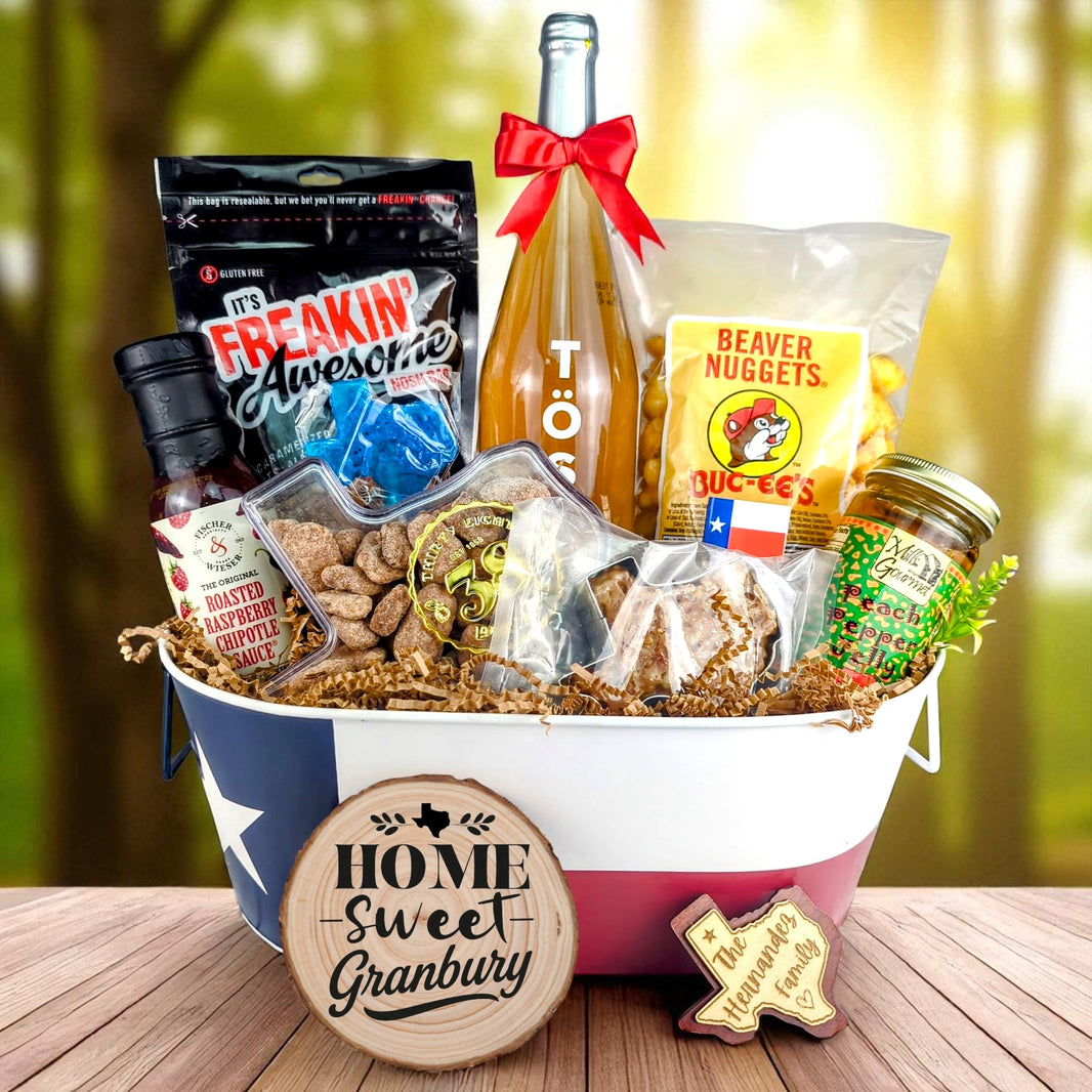 Granbury Texas Home Toast & Treats basket with TÖST ROSÉ, Peach Pepper Jelly, Buc-ee’s Beaver Nuggets, Texas pecans, praline, chipotle sauce, and Texas flag tin