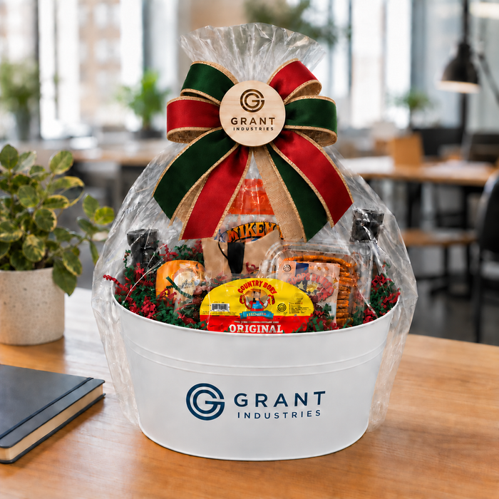 Fictional Grant Industries branded Texas holiday gift basket with red and evergreen ribbon and paper shred