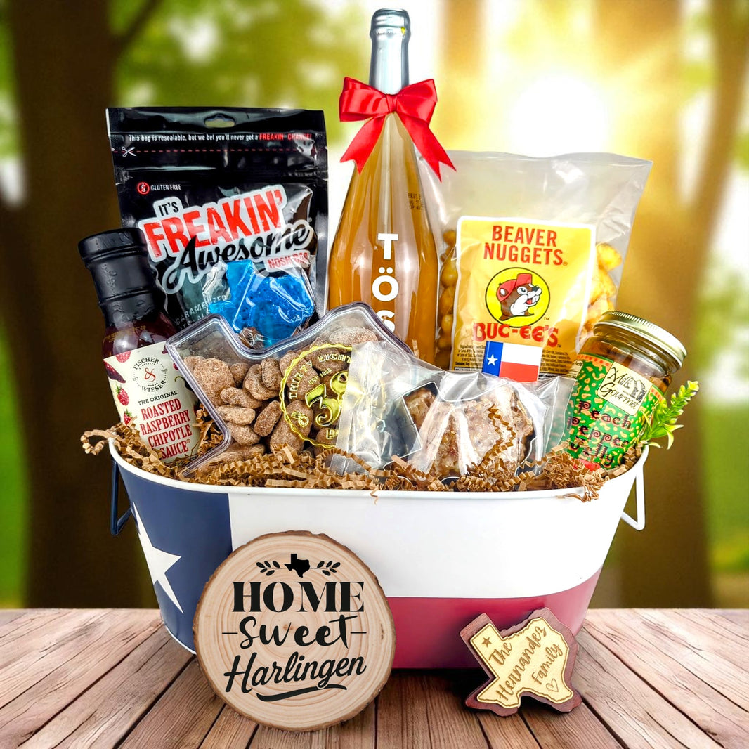 Harlingen Texas Home Celebration Toast & Treats basket with TÖST ROSÉ, Peach Pepper Jelly, Buc-ee’s Beaver Nuggets, Texas pecans, praline, chipotle sauce, and Texas flag tin