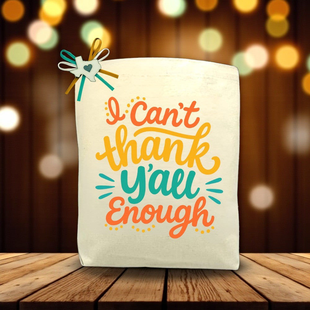 I Can’t Thank Y’all Enough canvas tote bag with heartfelt gratitude design, displayed on a wooden table.