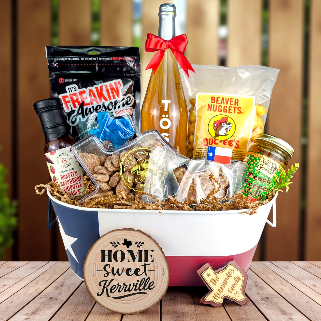 Kerrville Texas Home Toast & Treats basket with TÖST ROSÉ, Peach Pepper Jelly, Buc-ee’s Beaver Nuggets, Texas pecans, praline, chipotle sauce, and Texas flag tin