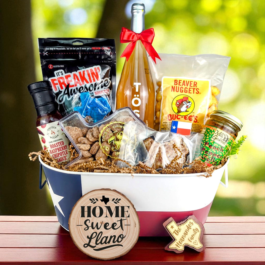 Llano Texas Home Celebration Toast & Treats basket with TÖST ROSÉ, Peach Pepper Jelly, Buc-ee’s Beaver Nuggets, Texas pecans, praline, chipotle sauce, and Texas flag tin