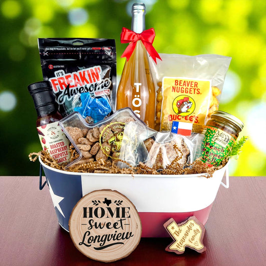 Longview Texas Family Home Toast & Treats basket with TÖST ROSÉ, Peach Pepper Jelly, Buc-ee’s Beaver Nuggets, Texas pecans, praline, chipotle sauce, and Texas flag tin