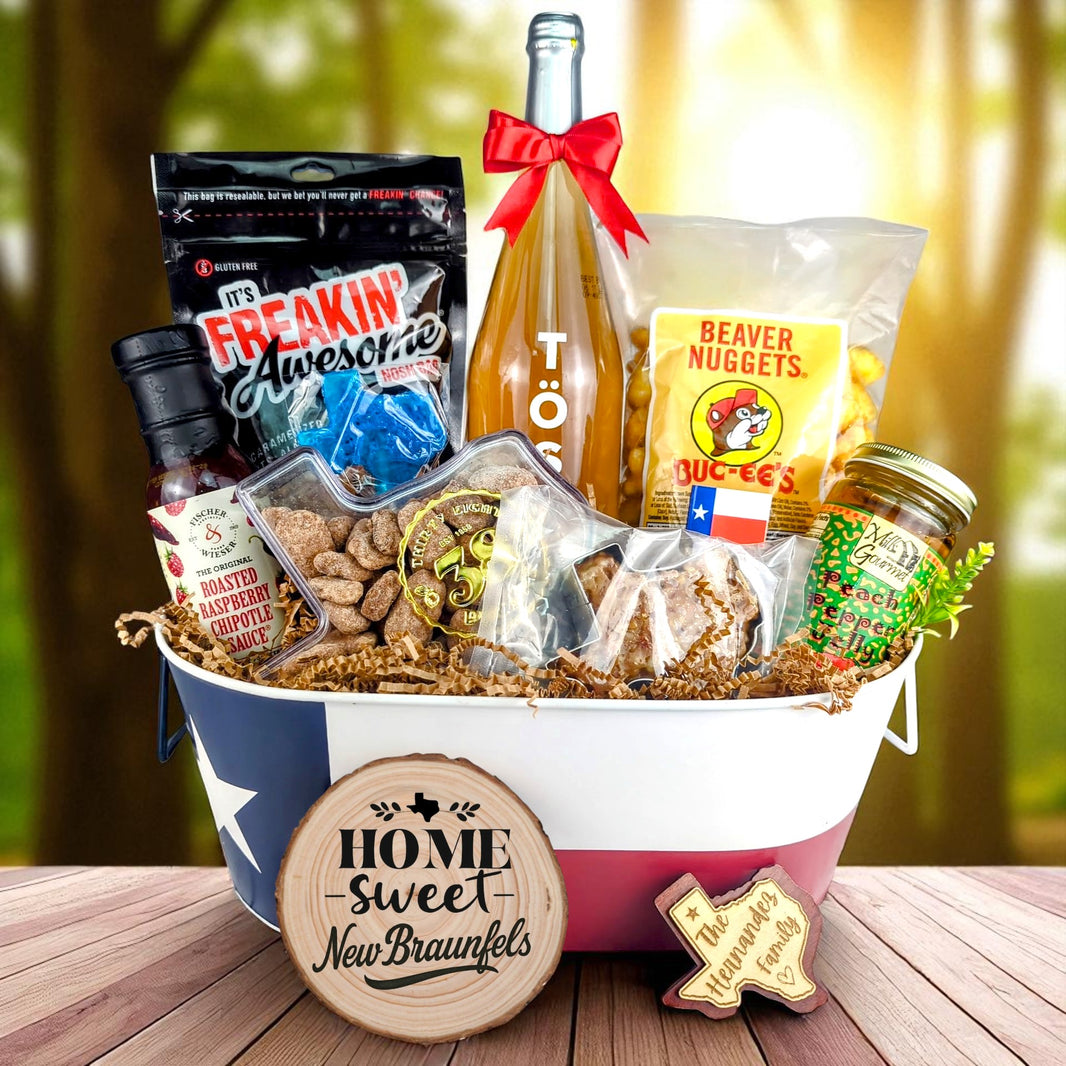New Braunfels Texas Homestyle Toast & Treats basket with TÖST ROSÉ, Peach Pepper Jelly, Buc-ee’s Beaver Nuggets, Texas pecans, praline, chipotle sauce, and Texas flag tin